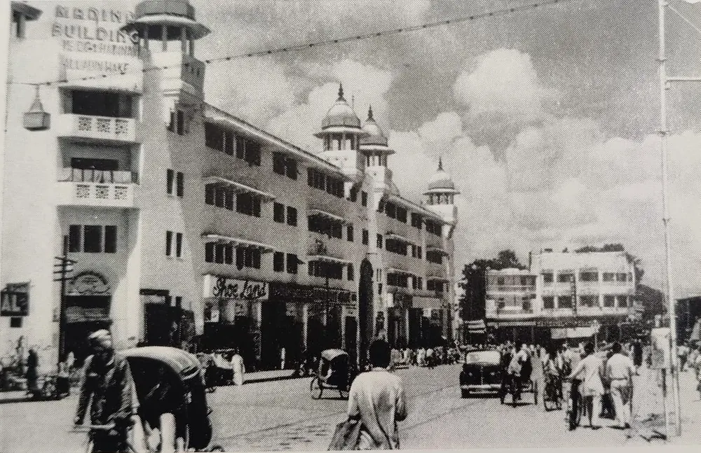 Archival photograph of the Madina Building on Pathergatti Road, Hyderabad, its name painted across the parapet beneath the domed turrets